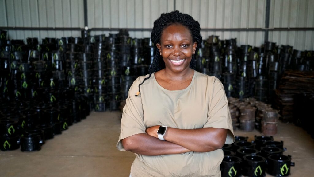 Charlot Magayi, Mukuru Clean Stoves, stands infront of the stoves