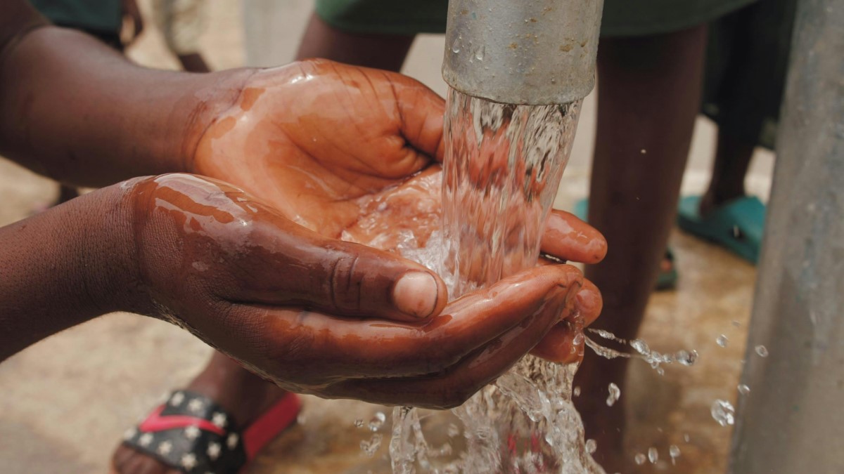 Hands catching water from a tap