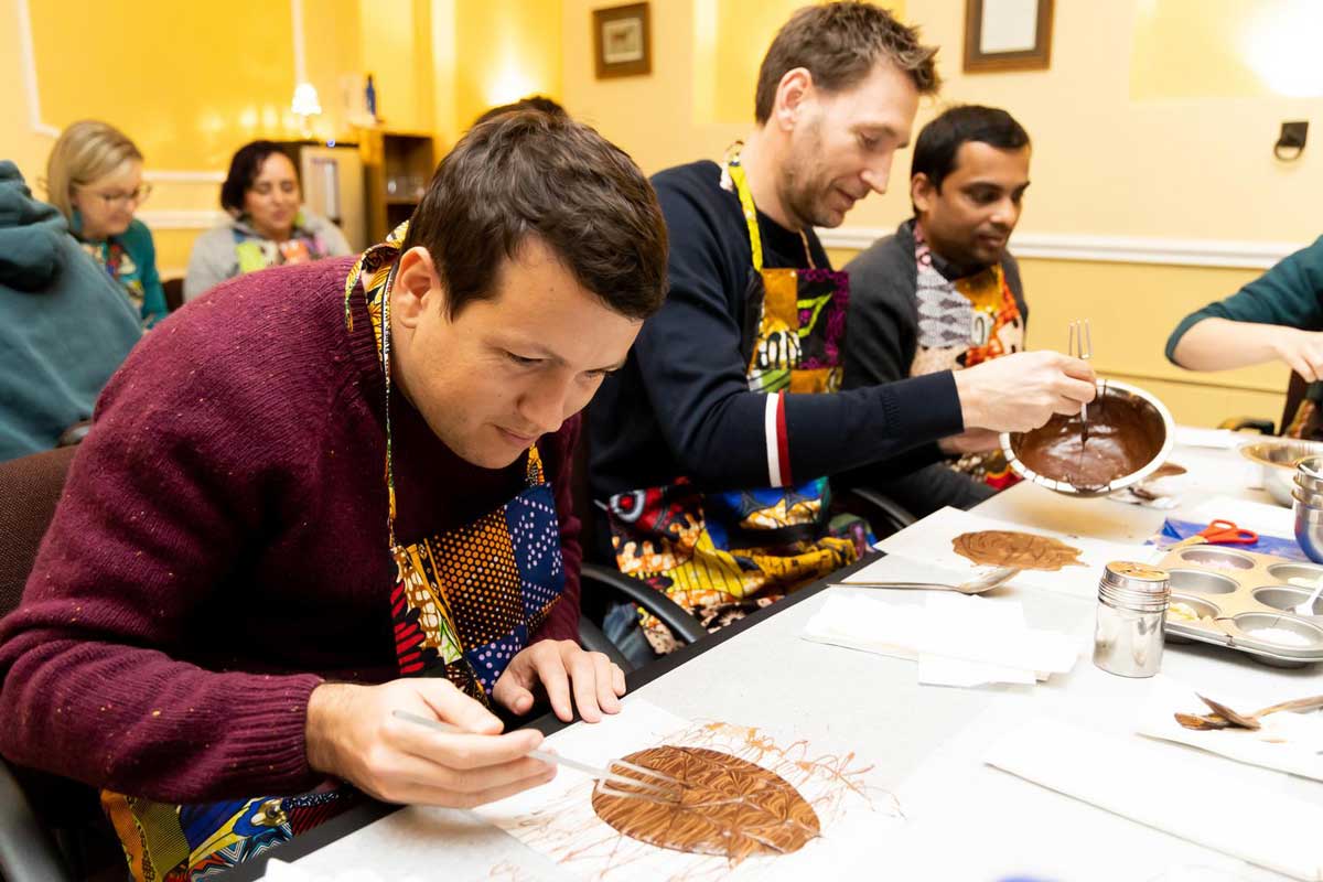 Pierre Paslier (Notpla), Christiaan Norde (City of Amsterdam) and Ankit Argarwal (Fleather) make chocolate