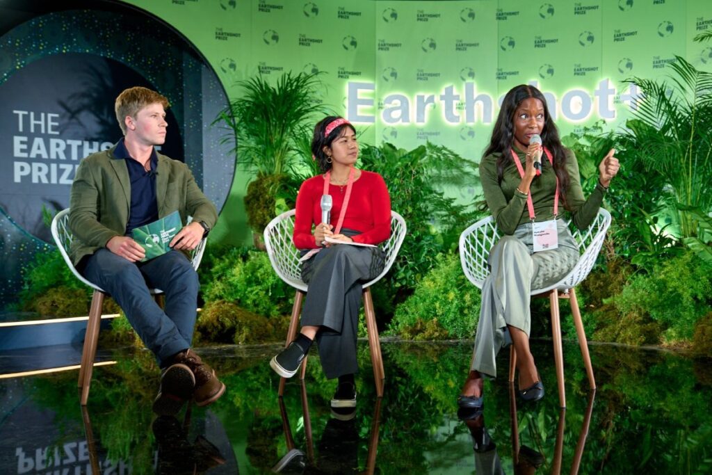 Natalie Mangondo (R) takes part in a panel discussion with fellow youth climate leader, Tasha Sabapathy, and Earthshot Prize Ambassador, Robert Irwin at Earthshot+ 2024 in Cape Town