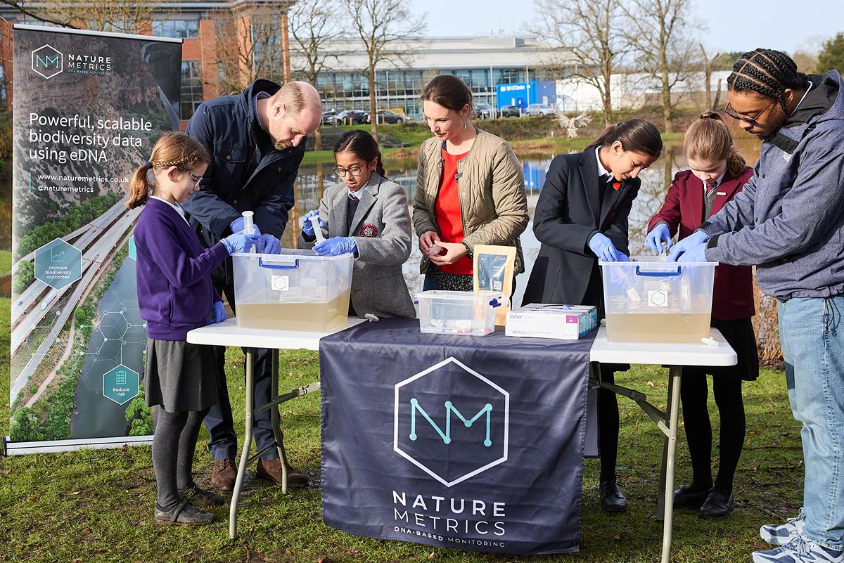 Prince William takes part in an experiment with schoolchildren, NatureMetrics founder, Dr Kat Bruce and science communicator, Big Manny