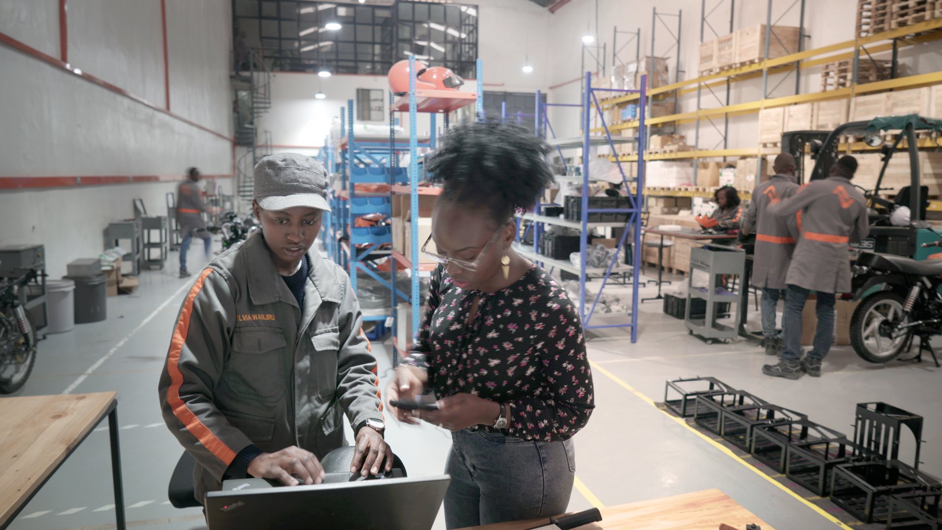 Roam factory workers look at laptop