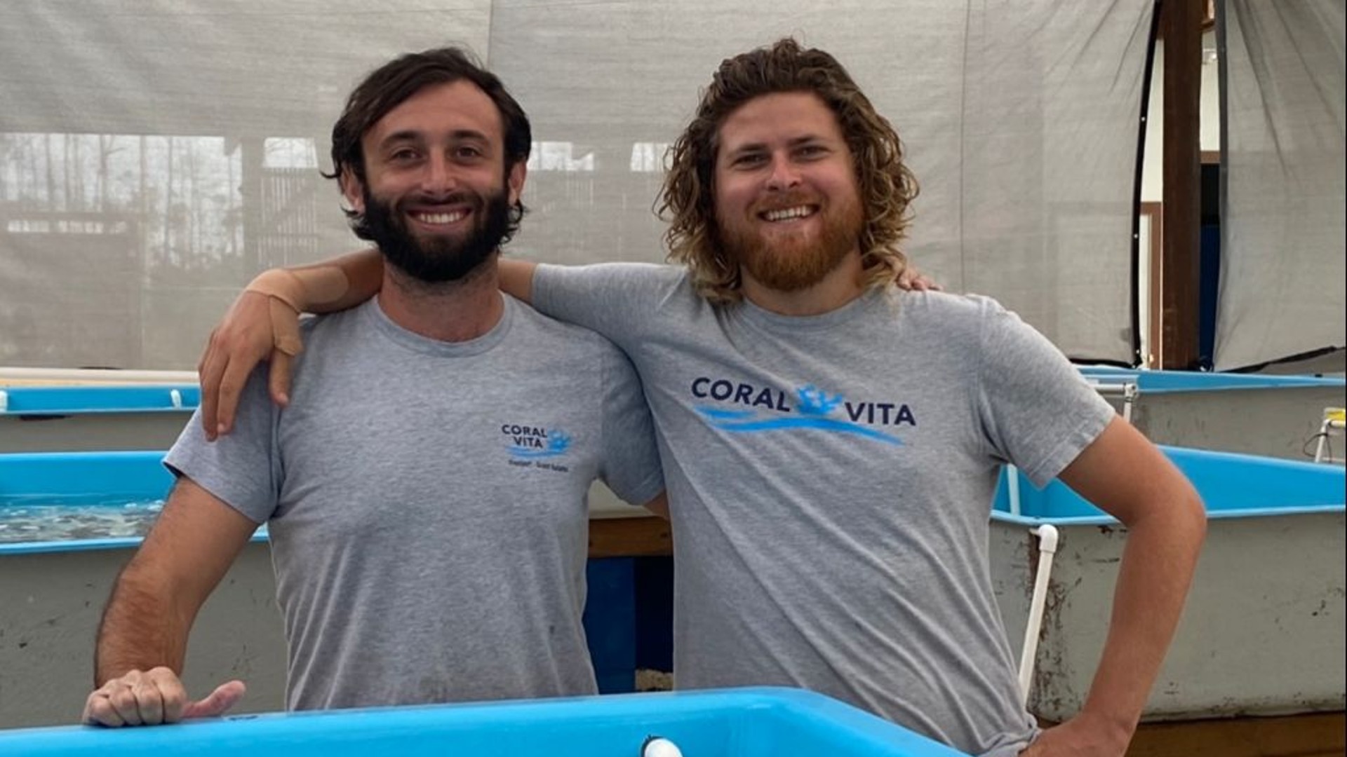 Sam Teicher and Gator Halpern stand at Coral Vita tank