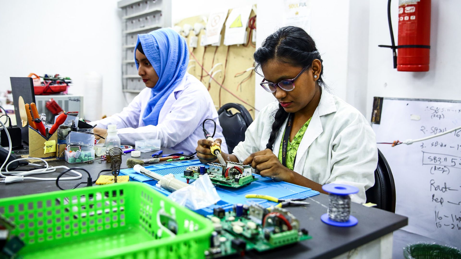 SOLshare workers solder circuit boards