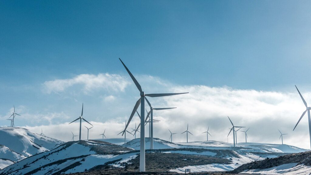 Wind turbines on snowy mountain tops